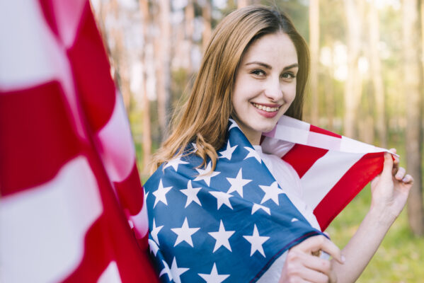 smiling-woman-wrapped-national-american-flag-lash-extension